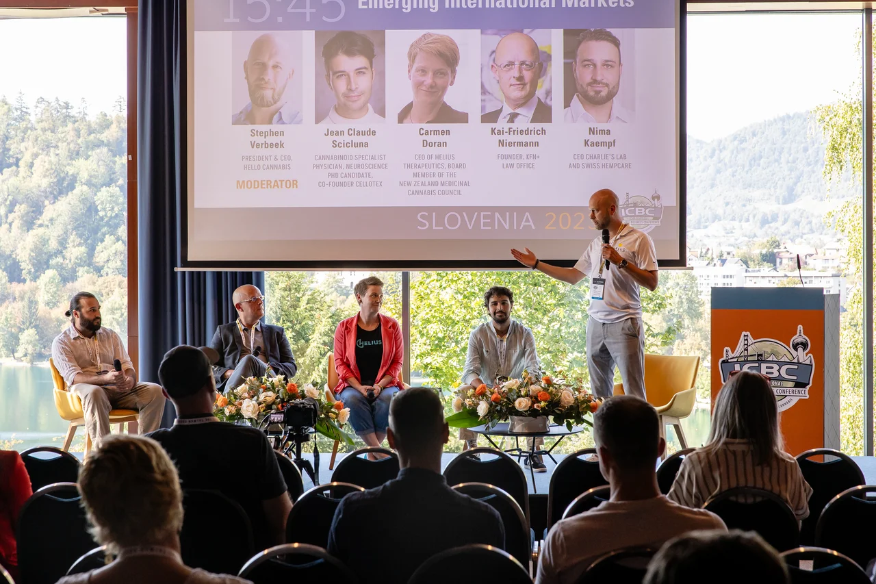A panel on stage beside a lake. On the large screen behind them are five portraits with names and titles, among them Kai-Friedrich Niermann, Founder KFN+ Law Office. At the bottom of the screen it says SLOVENIA 2023 and ICBC's logo.