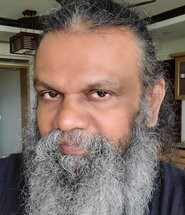 Portrait of Sajimon Parayil from the order's or the house's own website.